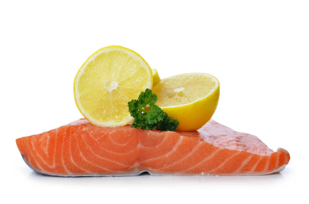 istock Fresh raw salmon fillet with lemons. 910786686