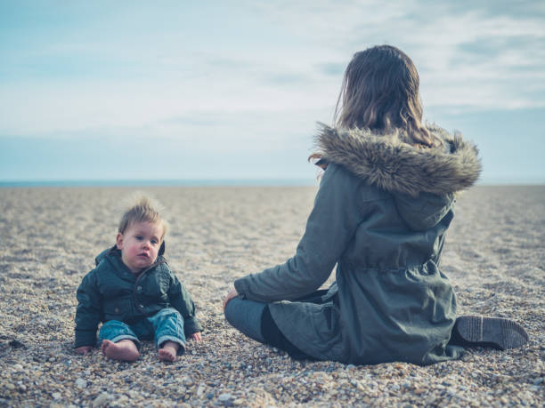 istock Mother with baby on the beach 910790532