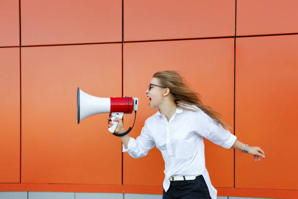 istock Girl activist yelling at loudspeaker 910791194