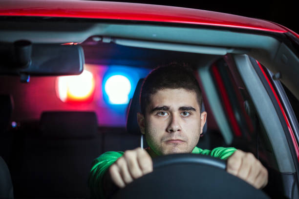 istock Police stopping a driver at night 910794020