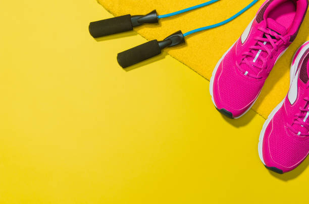 istock Fitness accessories on yellow background mock up, top view 910795174