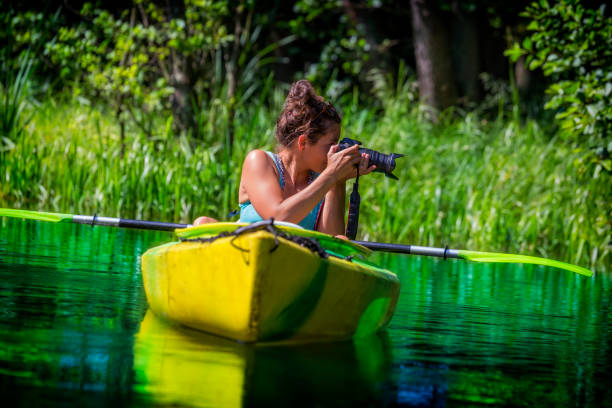istock Photographer on vacation in a kayak 910802150