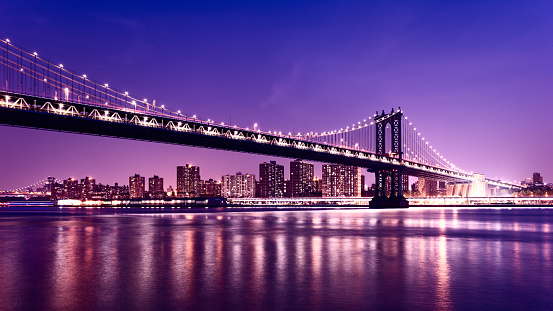 Manhattan Bridge at night. Williamsburg bridge and Manhattan cityscape in background