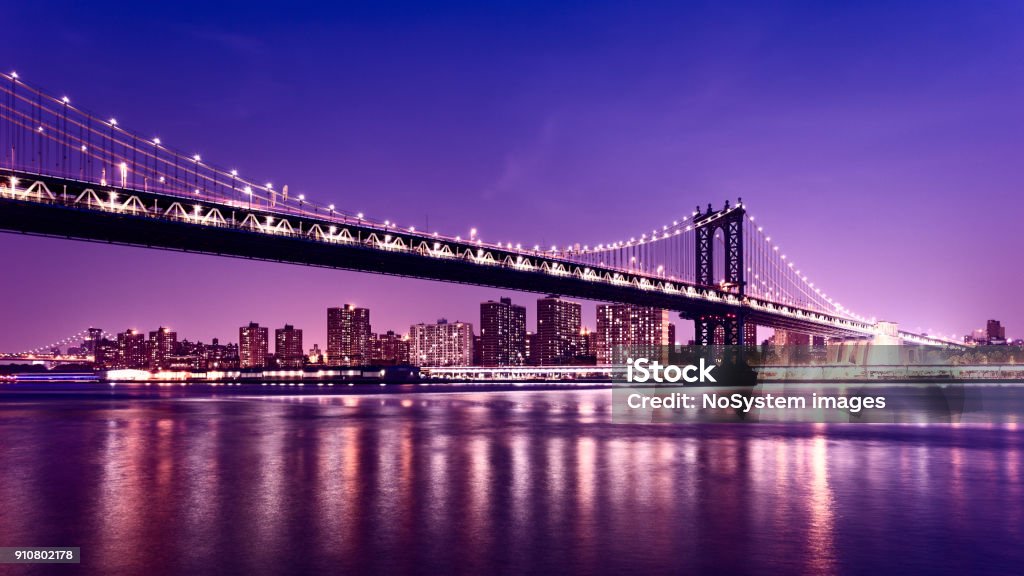 Manhattan Bridge at night. Williamsburg bridge and Manhattan cityscape in background Manhattan - New York City Stock Photo