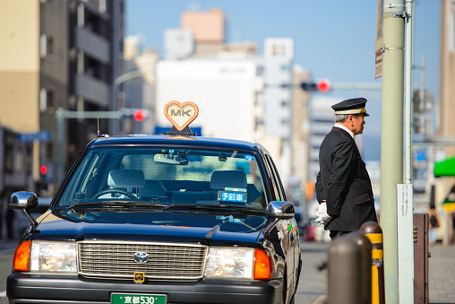 Kyoto, Japan - March 28, 2015 : Taxi driver waiting customers in Kyoto.