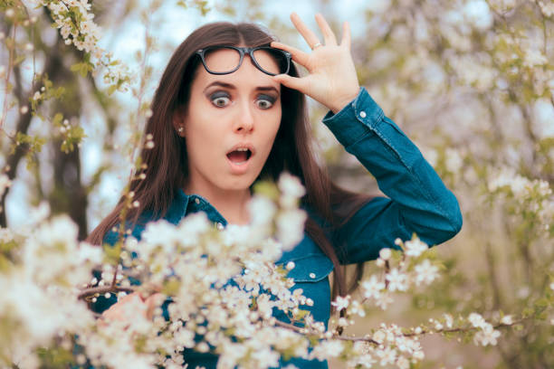 funny girl, environnée par les arbres fleurs peur des allergies - detective spy women fashion photos et images de collection