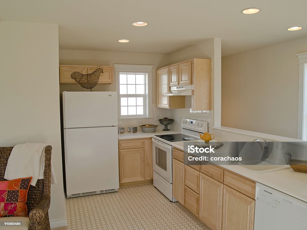 A Small Kitchen With White Appliances And Beige Walls Stock Photo ...