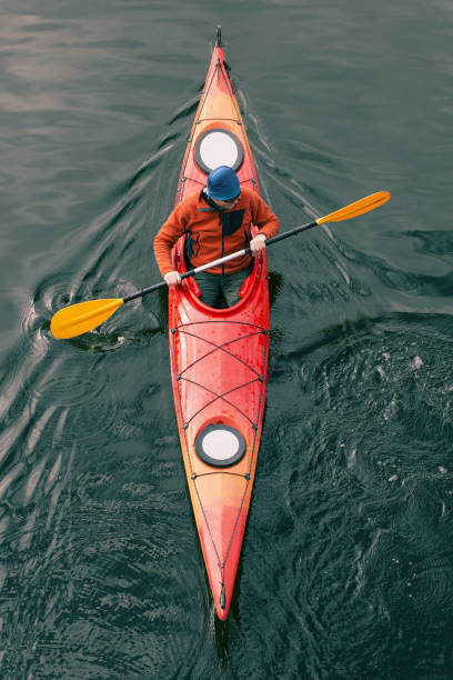 A man rafts down the river on a kayak.