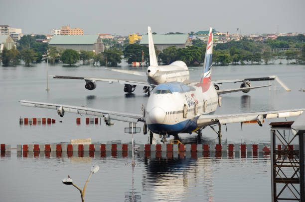 Airplanes drown in the water at Don Muang International Airport during the massive flood crisis stock photo