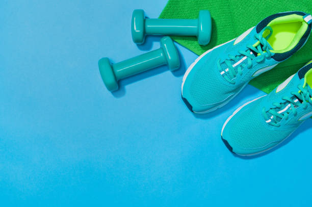 istock Fitness accessories on blue background mock up, top view 910805628