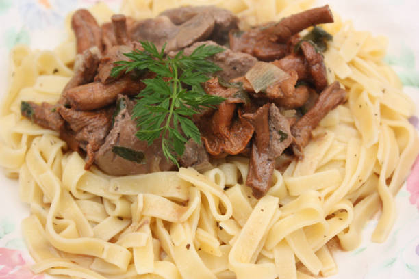Veal kidney cooked with Madeira sauce and chanterelle mushrooms Veal kidney cooked with Madeira sauce and chanterelle mushrooms  served with noodles madeira sauce stock pictures, royalty-free photos & images