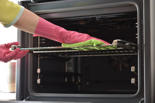 Cleaning oven. Clean oven in kitchen. Cleaning the oven. Woman's hand in household cleaning gloves cleans oven inside. Clean oven in kitchen. oven stock pictures, royalty-free photos & images