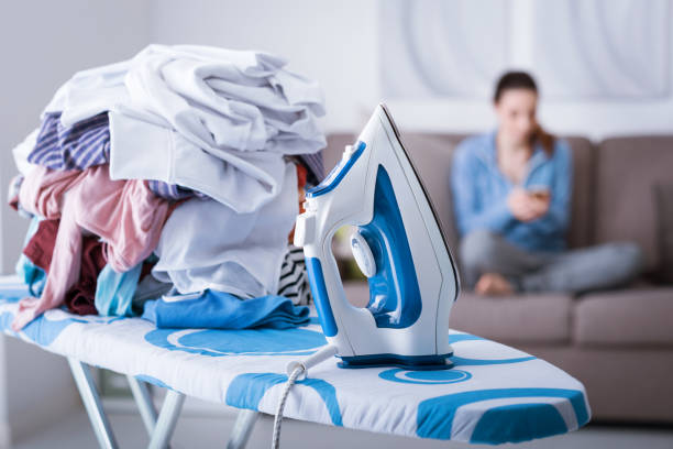 lazy housewife on the couch - iron women ironing board stereotypical housewife imagens e fotografias de stock