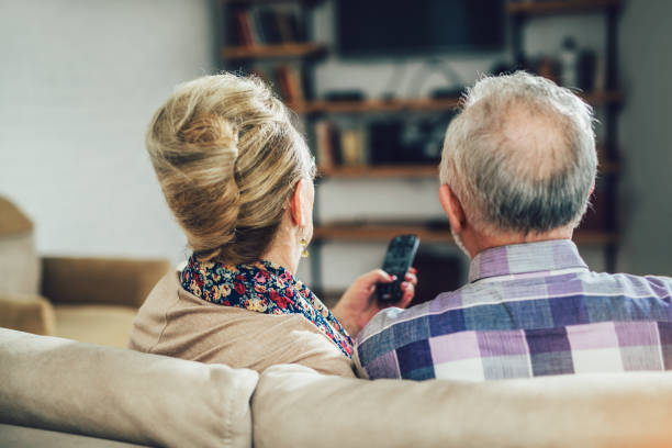 Senior couple watching television show