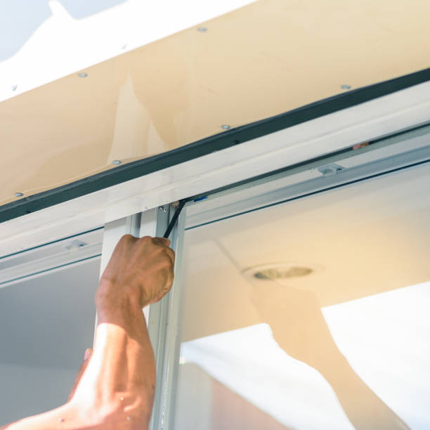 istock hand with screwdriver, tighten the screw stopper window. 910827184