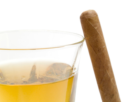 alcoholic drink, whiskey and cigar on brown wooden background