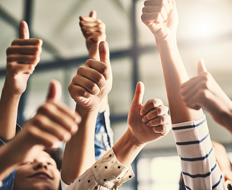 Closeup shot of a group of unrecognizable people showing thumbs up together