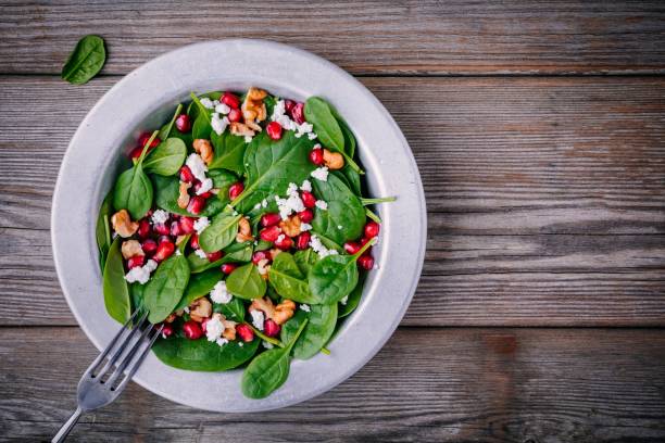 istock Fresh green salad with spinach, walnuts, feta cheese and pomegranate 910836154