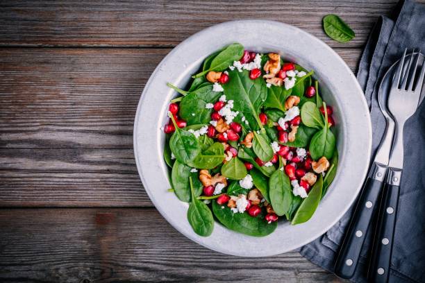 istock Fresh green salad with spinach, walnuts, feta cheese and pomegranate 910836270
