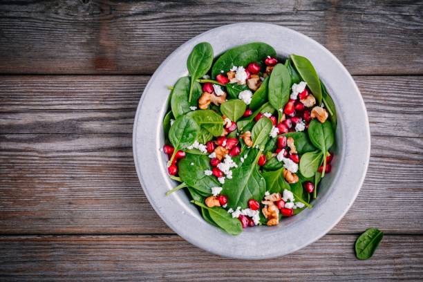 istock Fresh green salad with spinach, walnuts, goat cheese and pomegranate 910836326