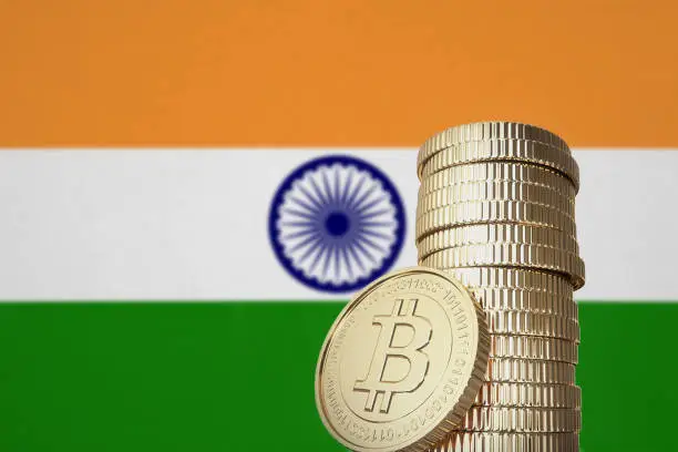Bitcoin stack with a national flag in the background