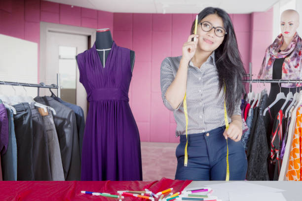 istock Beautiful fashion designer thinking something 910840730