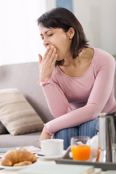 istock Sleepy woman waking up 910840778