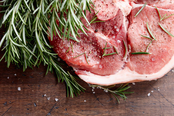 istock Raw pork with rosemary , salt and pepper. 910843536