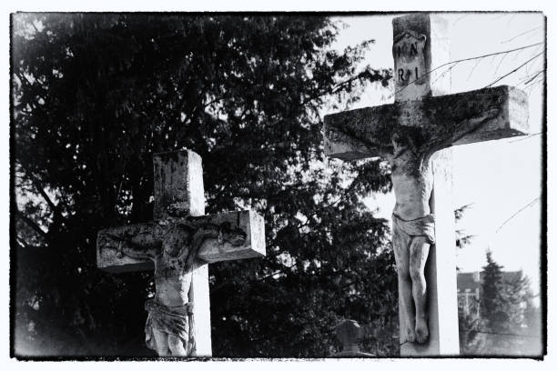 Crucifixion. A detail from an old cemetery. Post processed . The crucifixion of Jesus with the initialism INRI representing latin inscription Iesus Nazarenus Rex Iudaeorum which in English reads as "Jesus the Nazarene, King of the Jews". A detail from an old cemetery. Grain noise added. Post-processed to look like an old photo. the crucifixion audio stock pictures, royalty-free photos & images