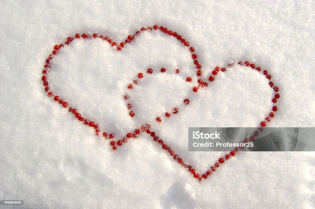 Two hearts on snow  Berry Stock Photo