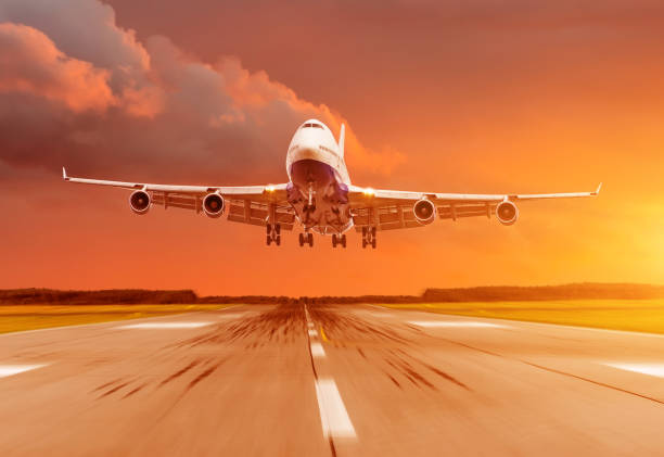 istock Passenger airplane landing at sunset on a runway. 910850846