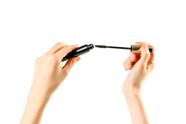 istock Hands holding a mascara on white background. Closeup 910851490