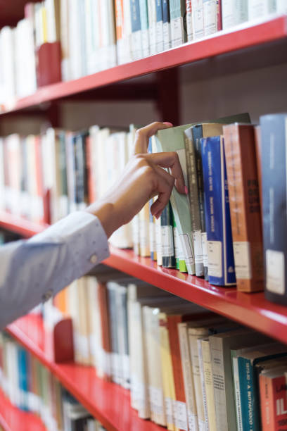 student searching books - library young adult bookstore people imagens e fotografias de stock