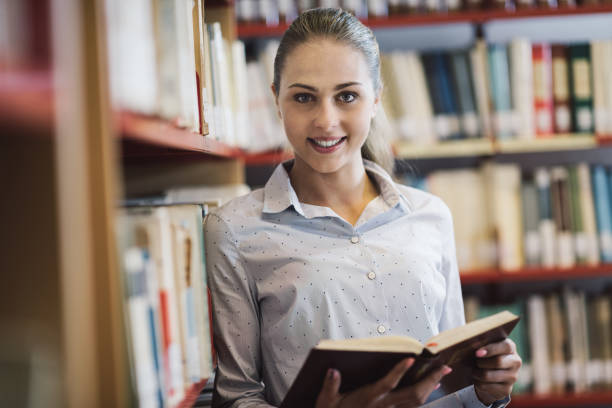 istock Woman searching books at the library 910852274