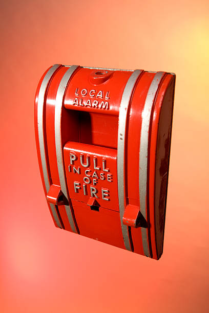 Old Fire Alarm on Flame and Smoke Background stock photo