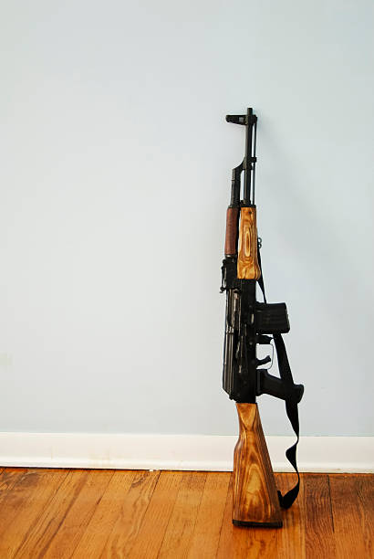 ak-47 with space for text ak-47 against a light blue wall, space for text ak 47 bullets stock pictures, royalty-free photos & images