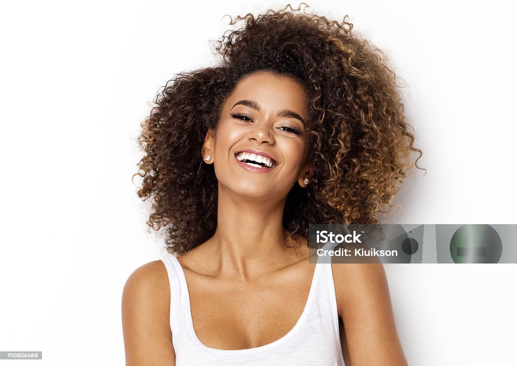 Beautiful african american female model Beautiful african american girl with an afro hairstyle smiling Women Stock Photo