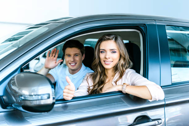 istock Boyfriend and girlfriend in a new car 910858872