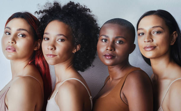 Proof that there is no one way to be beautiful Studio shot of a group of beautiful young women posing together against a gray background complexion photos stock pictures, royalty-free photos & images