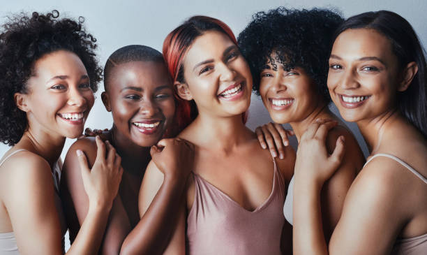 Our differences don’t divide us, they unite us Studio shot of a group of beautiful young women posing together against a gray background melanin photos stock pictures, royalty-free photos & images