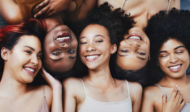 Beautiful people see beauty in others High angle shot of a group of beautiful young women lying next to each other melanin photos stock pictures, royalty-free photos & images