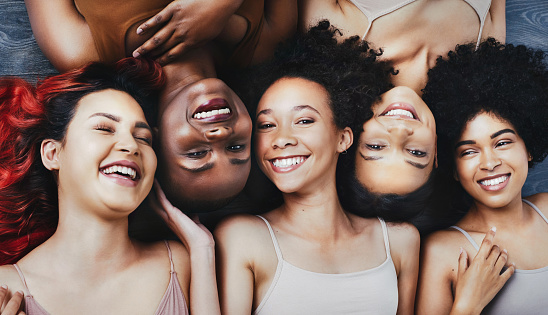 High angle shot of a group of beautiful young women lying next to each other