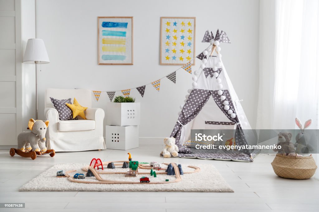 empty children's playroom with  tent and  toy railway an empty children's playroom with  ent and  toy railway Playroom Stock Photo
