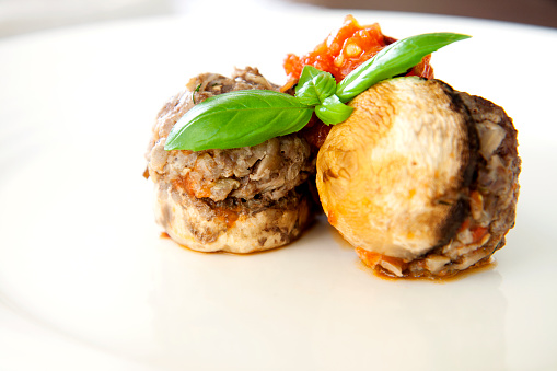 Oven baked white mushrooms stuffed with ground beef meatballs.