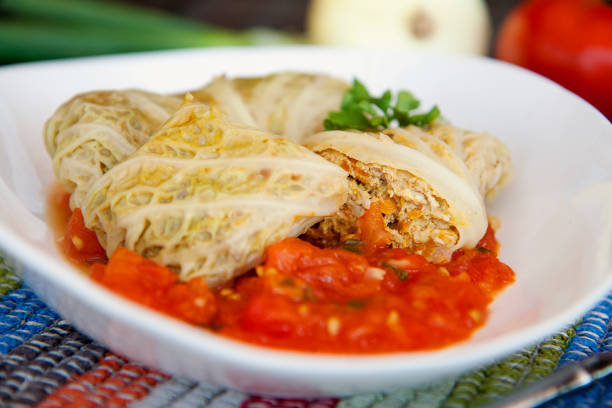 Side view of stuffed cabbage rolls with minced turkey meat in tomato sauce. stock photo