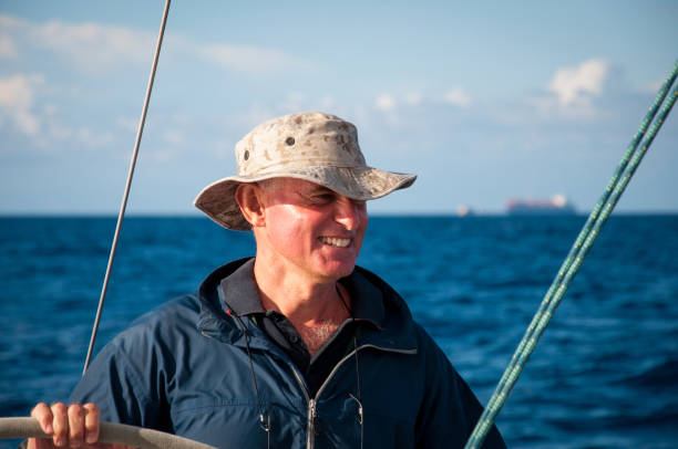 istock skipper sailing with his boat 910881100