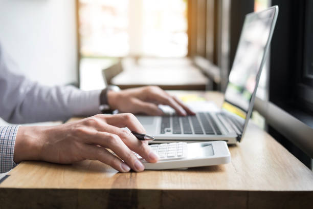 istock Cropped Image Of Man Using Laptop At Table 910881362