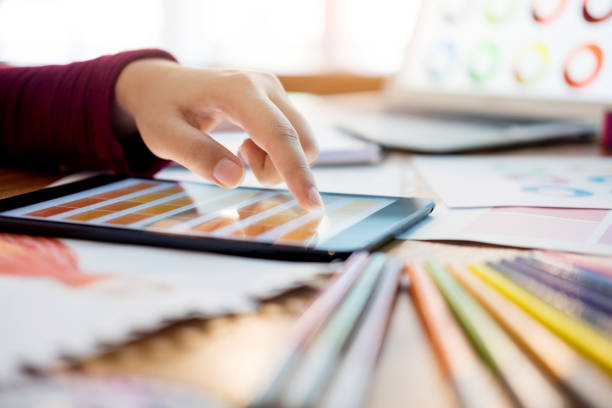 istock Cropped Image Of Hand Using Digital Tablet In Office 910881656