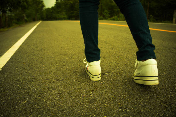 istock Low Section Of Man Standing On Road 910885074
