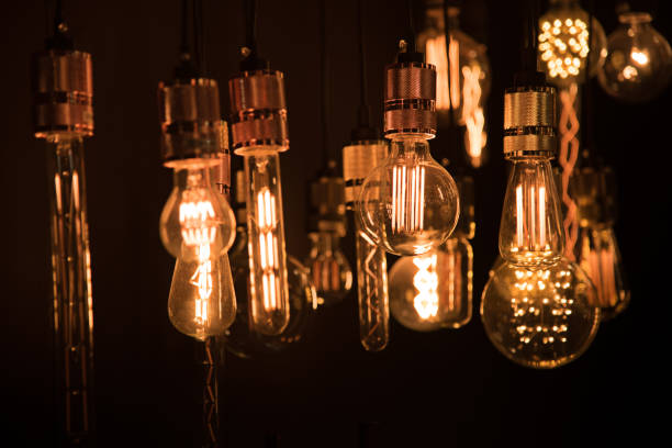 istock Illuminated Lighting Equipment Hanging In Darkroom 910887306